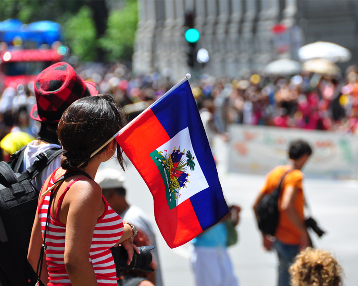 lady holding haitian flag during flag day